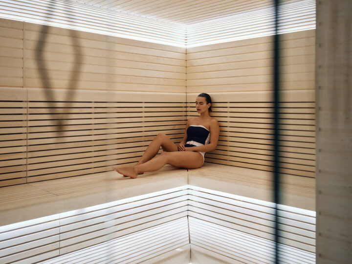 Woman sits in sauna at Orchard Place